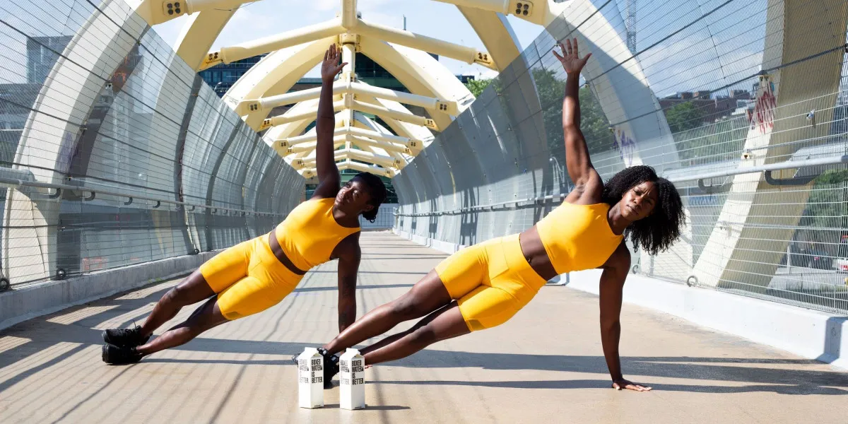 Two Women Exercising on Bridge