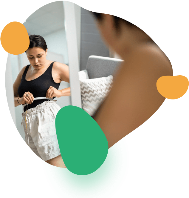 Woman Checking Waist Measurement in Mirror